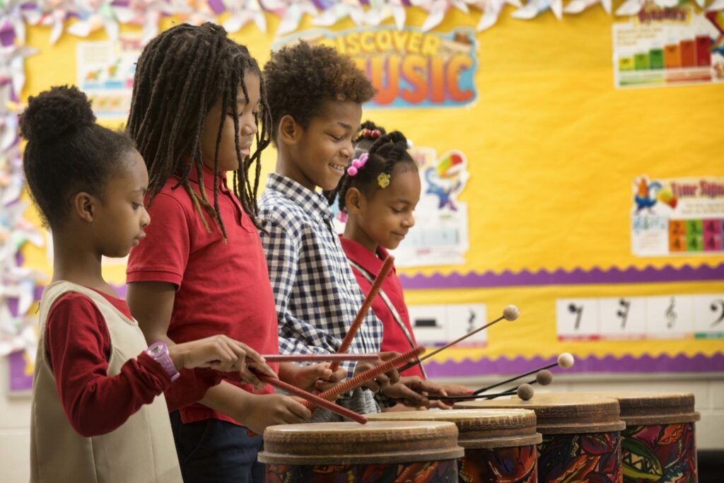 young children playing musical instruments