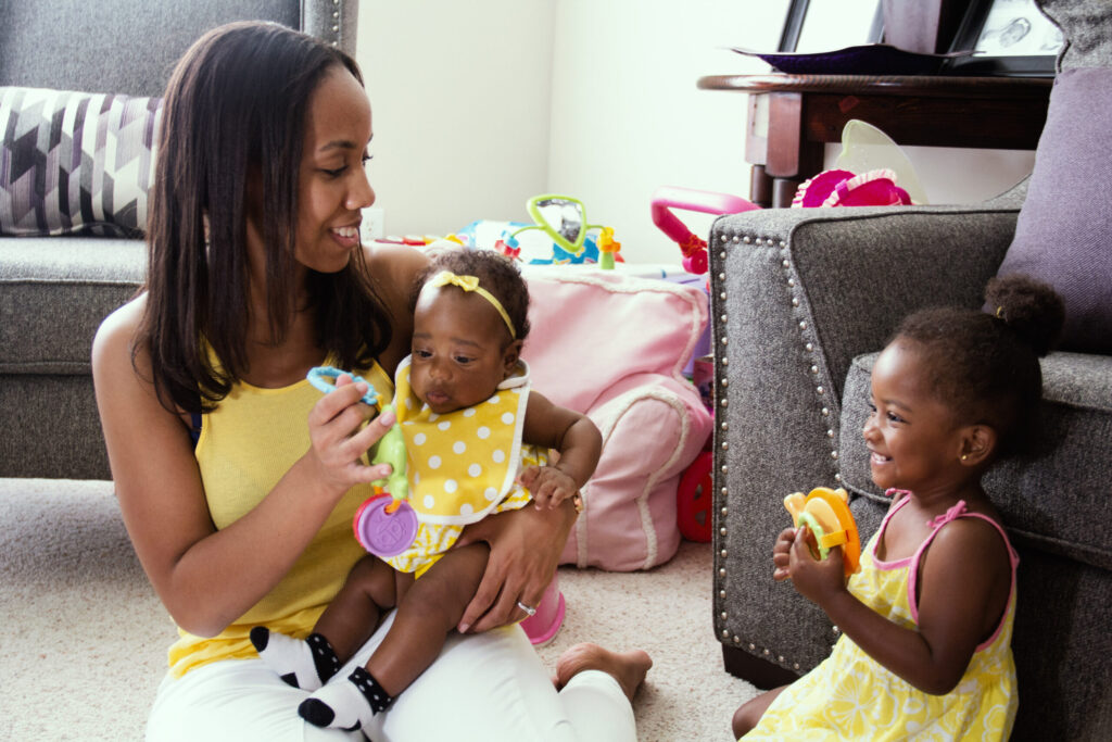 Mom playing with baby and preschool aged child